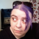 A fat girl with purple dyed hair records herself farting and taking a crackling, soft shit while sitting on a toilet. No product seen. About a minute.